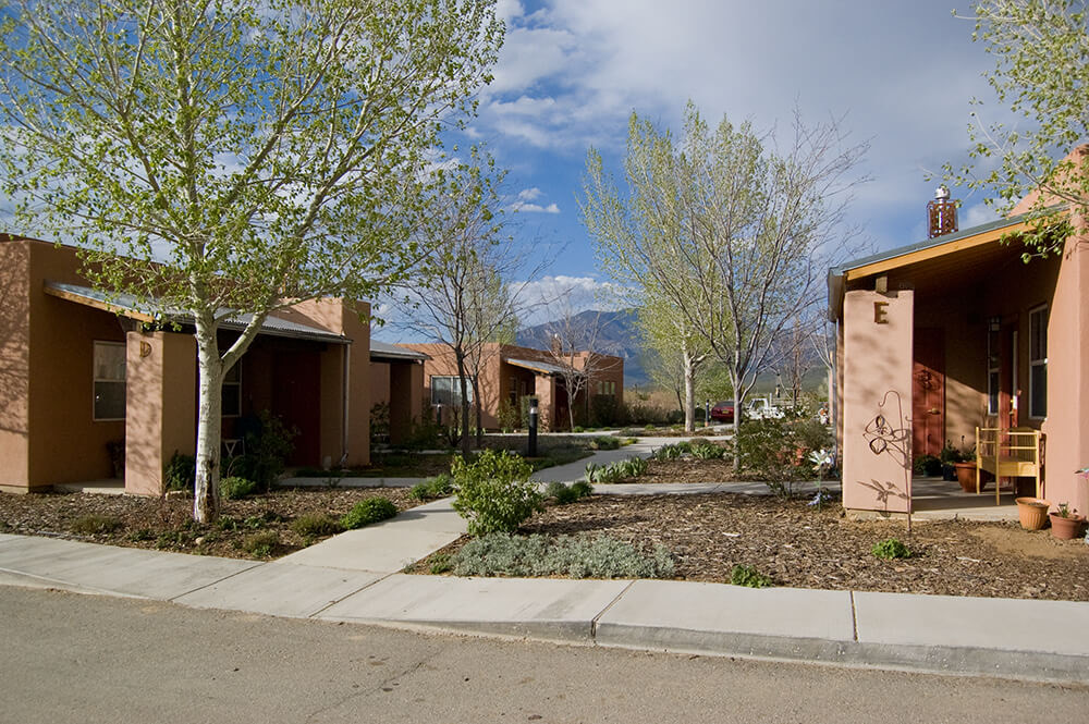 Covered porches and connected walkways between homes at Loma Parda in Taos, NM